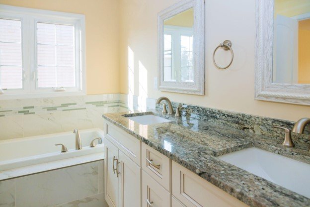 Bathroom countertop installation with double sinks and vanity cabinets in Colorado Springs, CO